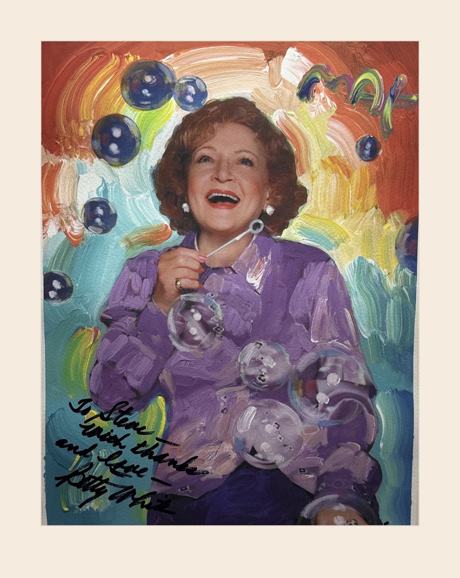 Peter Max painted portrait of Betty White blowing bubbles, painted from Stephen E. Terrell's photograph and signed to him by Betty White, presented on an ivory mat
